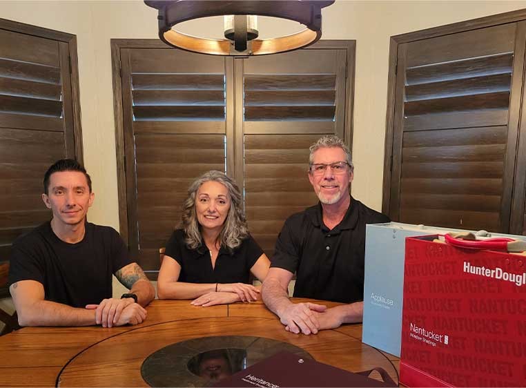 Dealership owners sitting at a table with Hunter Douglas branded cases