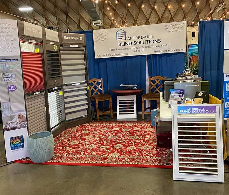 Affordable Blinds Solutions booth at a convention